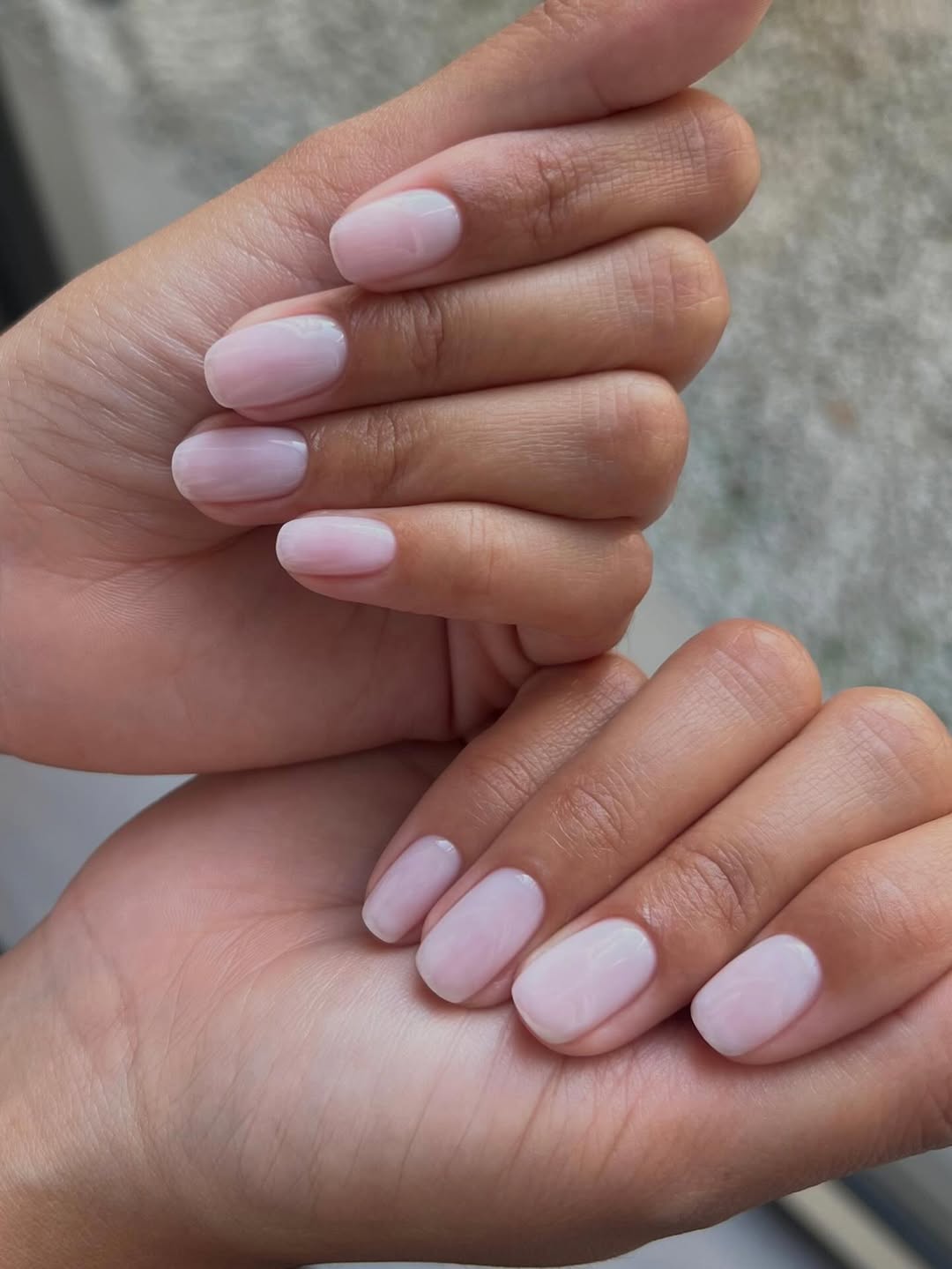 Pale pink nails.