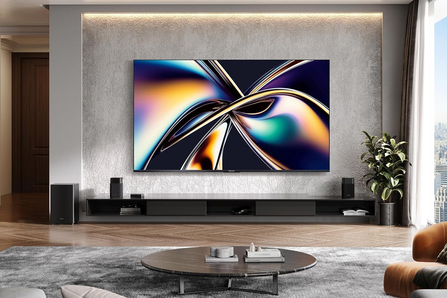 Hisense’s U65QF 4K TV mounted on a wall above a media center in a living room.