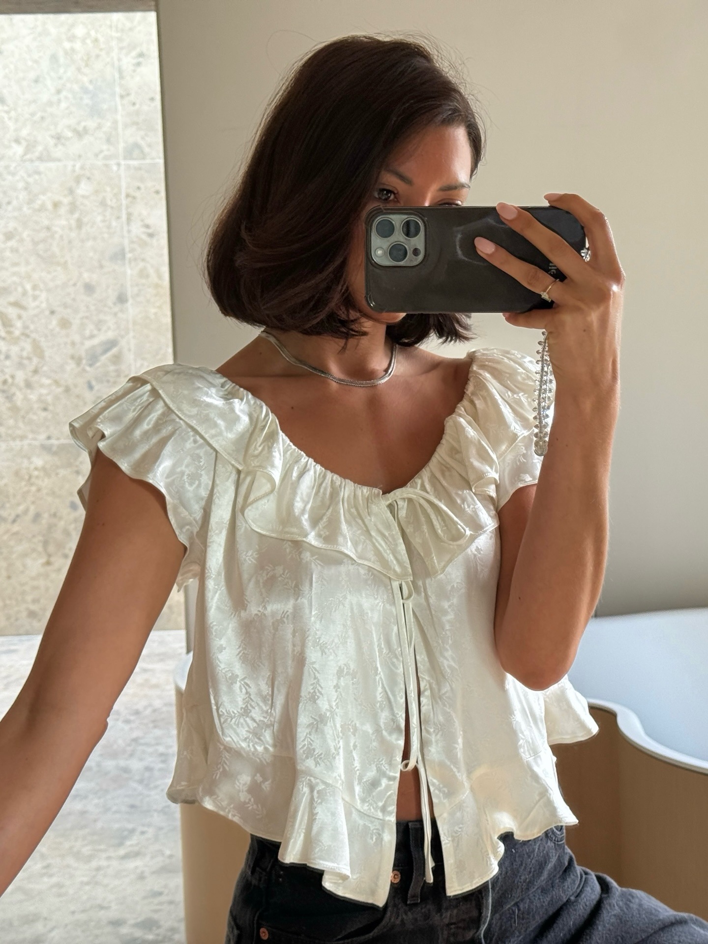 Marianne wearing white blouse
