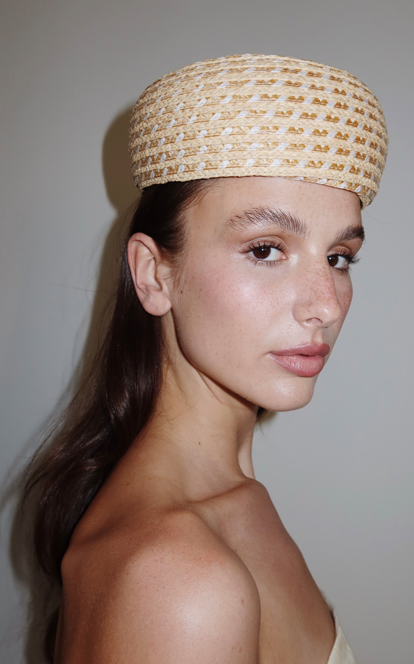 Moda Operandi model wearing a raffia pillbox hat