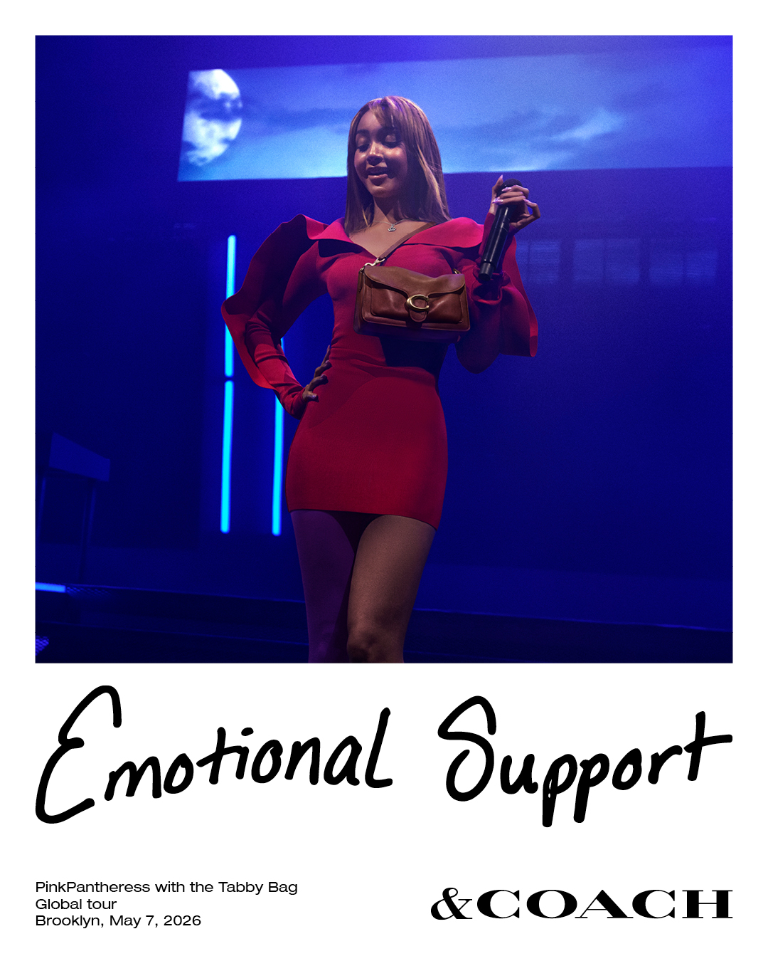 PinkPantheress wearing a red dress and a brown Coach bag on stage