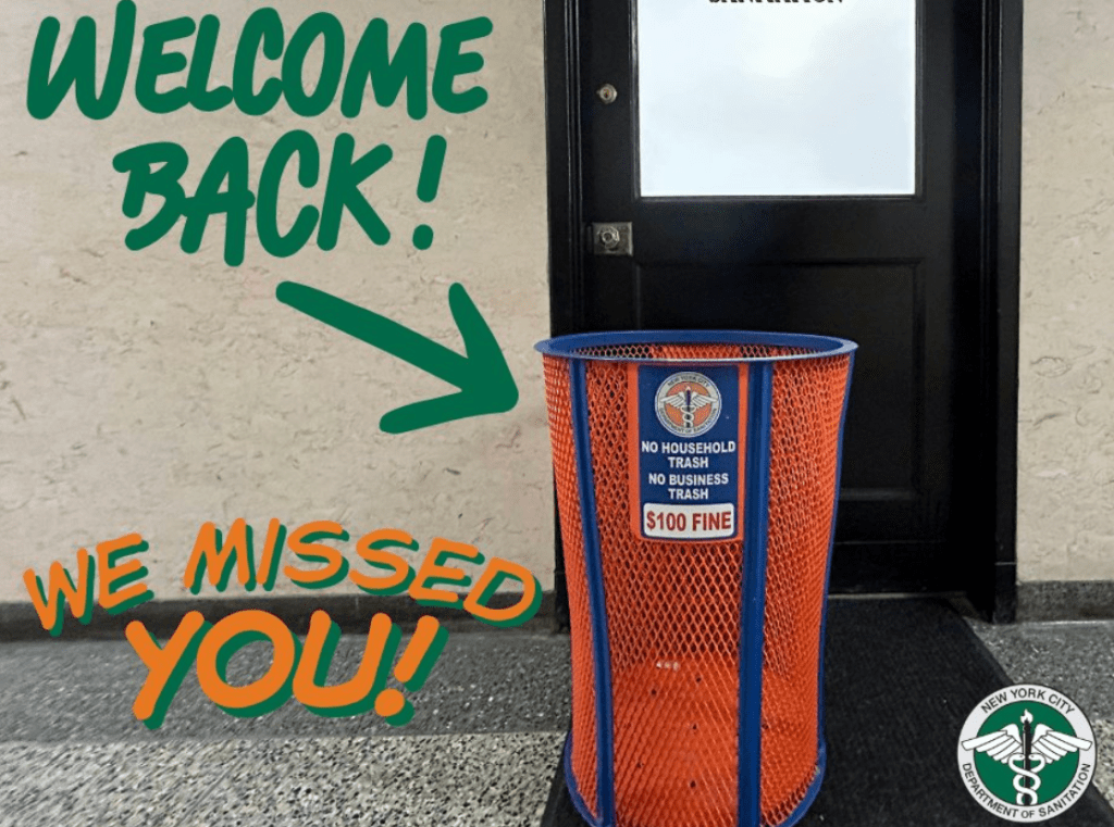 A sign reading "Welcome back!" with an arrow pointing to a trash can labeled "No household trash, no business trash, $100 fine" in front of a door.