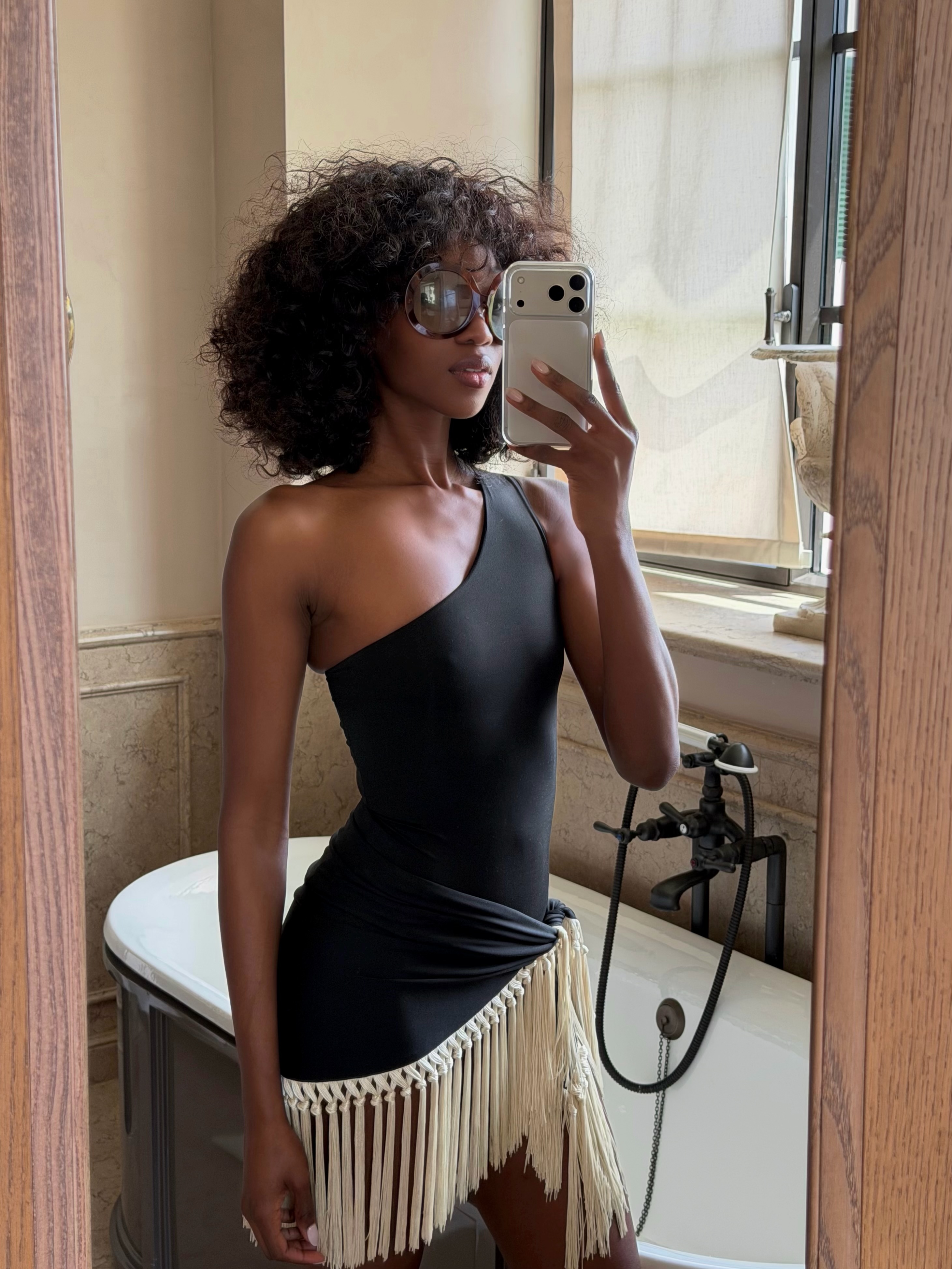 An image of a woman with a diffused afro hairstyle.