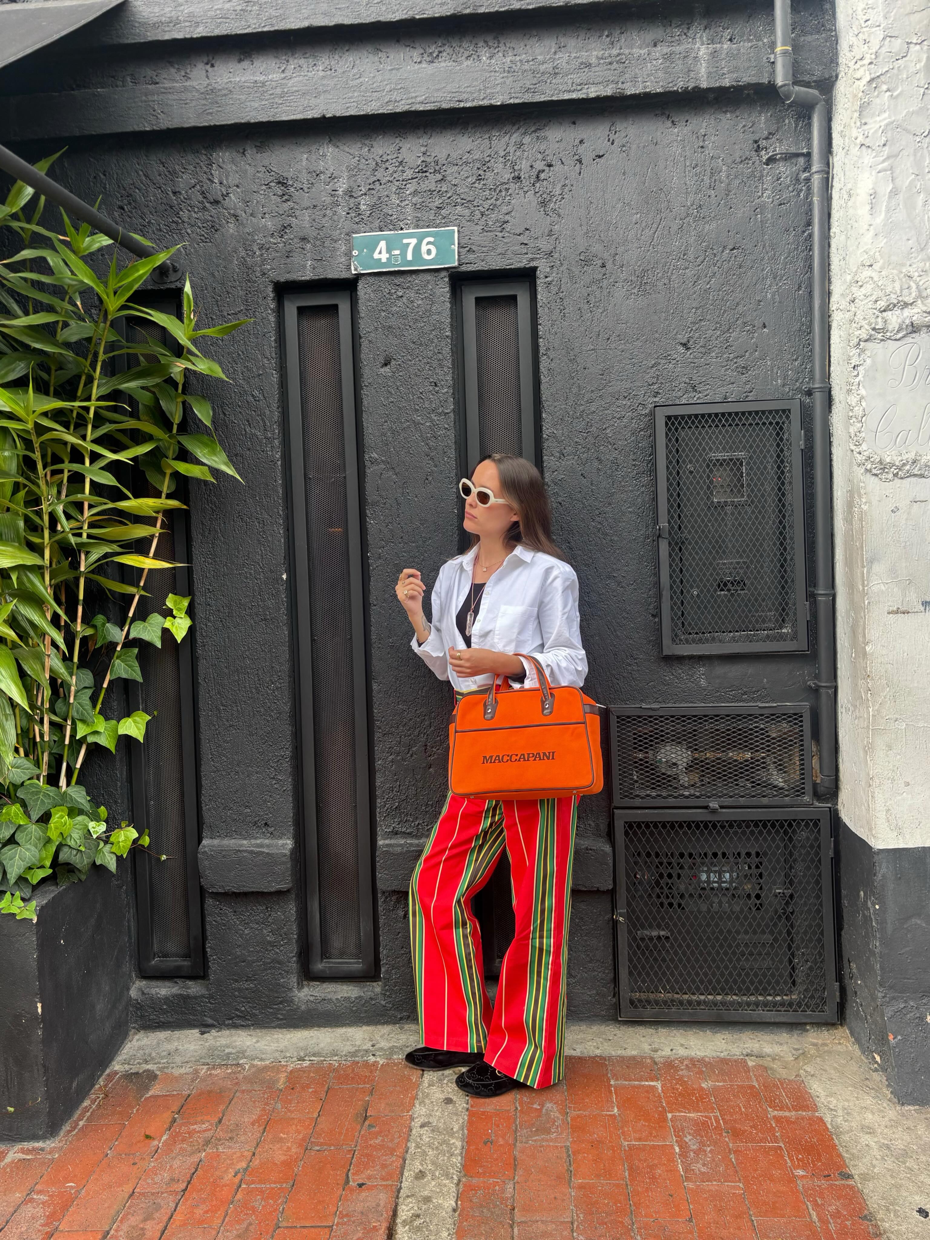 Woman wearing striped jeans, a strong summer 2026 trend.