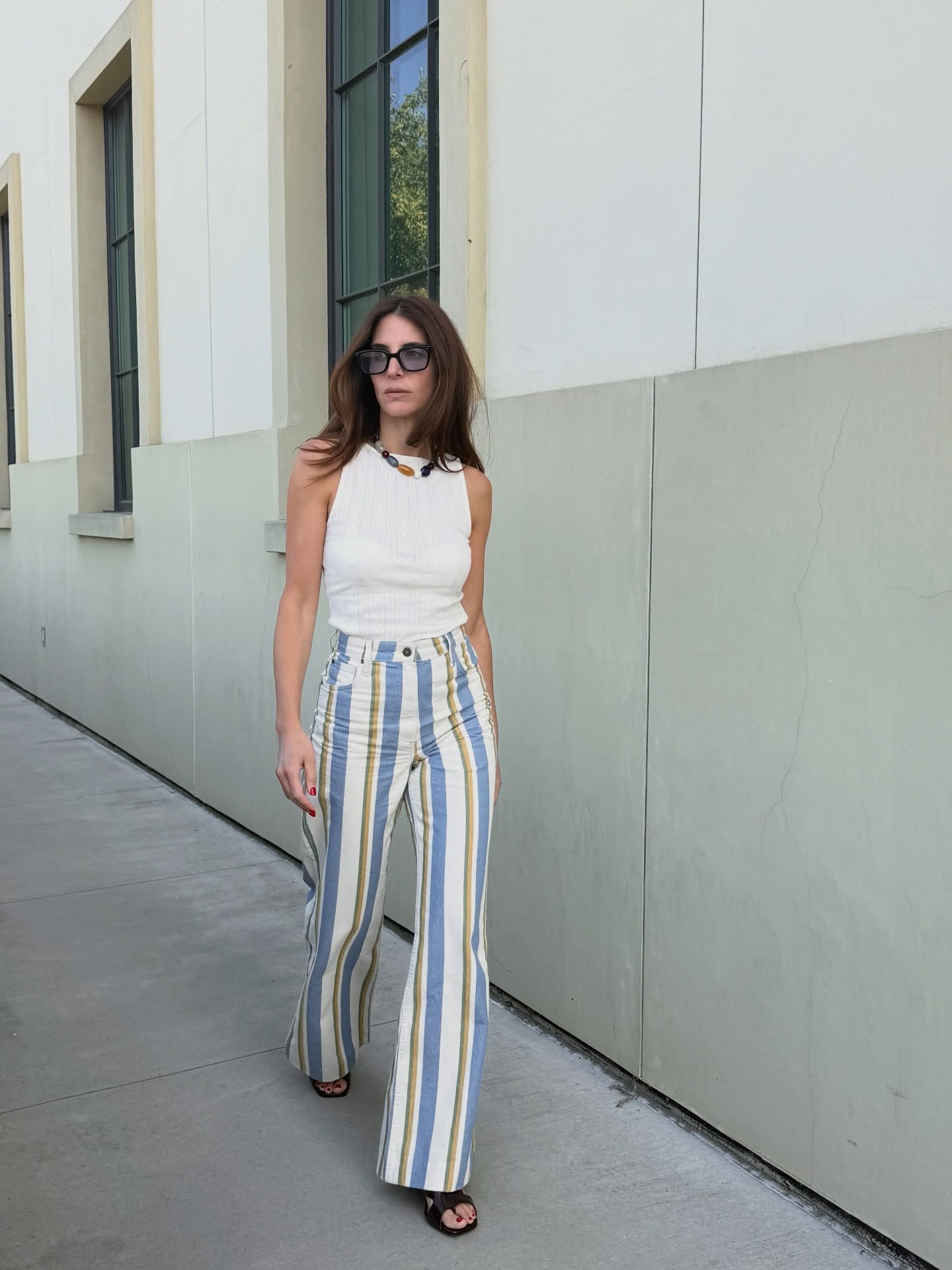 Woman wearing striped jeans, a strong summer 2026 trend.