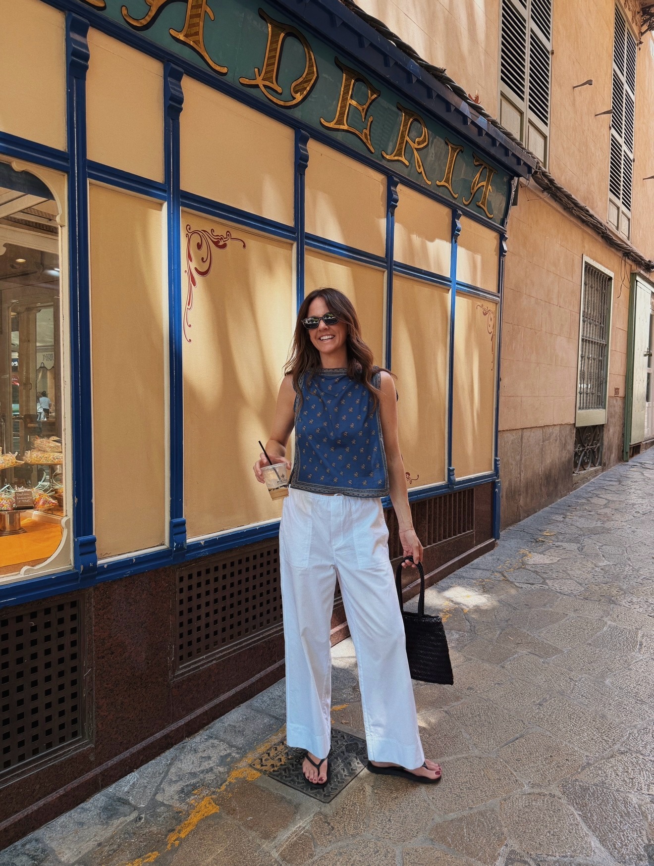Influencer wearing white trousers and blue top