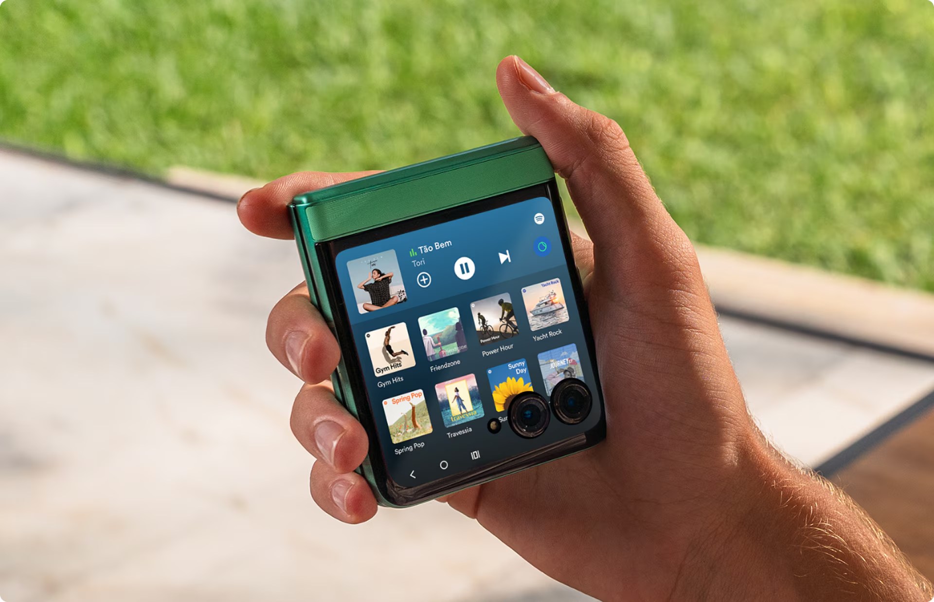 The Motorola Razr 2025 being held while showing the cover screen.
