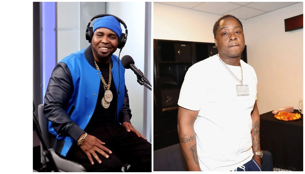 Two men, one wearing a blue jacket and headphones, the other wearing a white shirt and necklace, in what appears to be a recording studio or radio station.