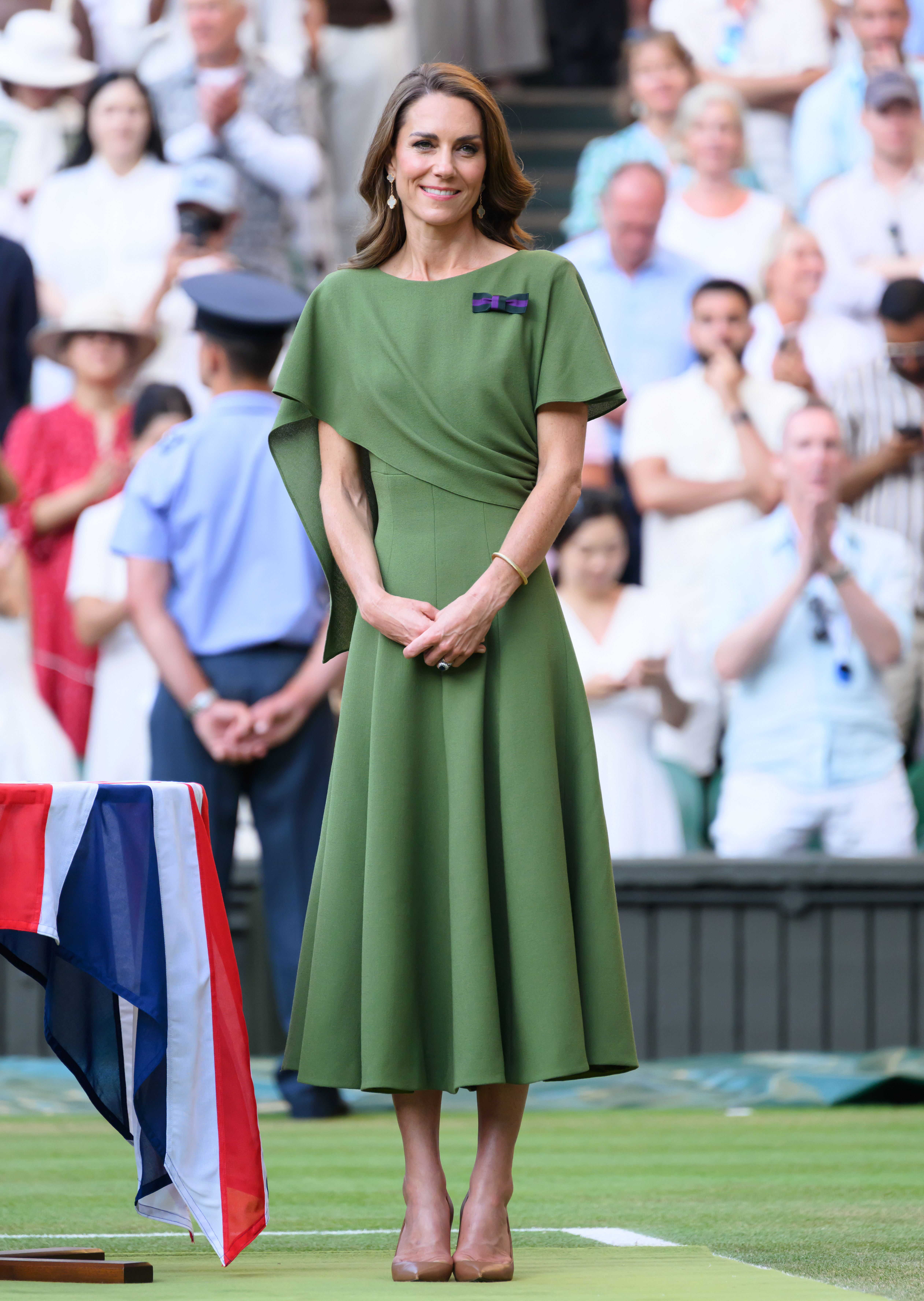 Kate Middleton wears an olive green dress with brown heels and a brown DeMellier bag at Wimbledon.