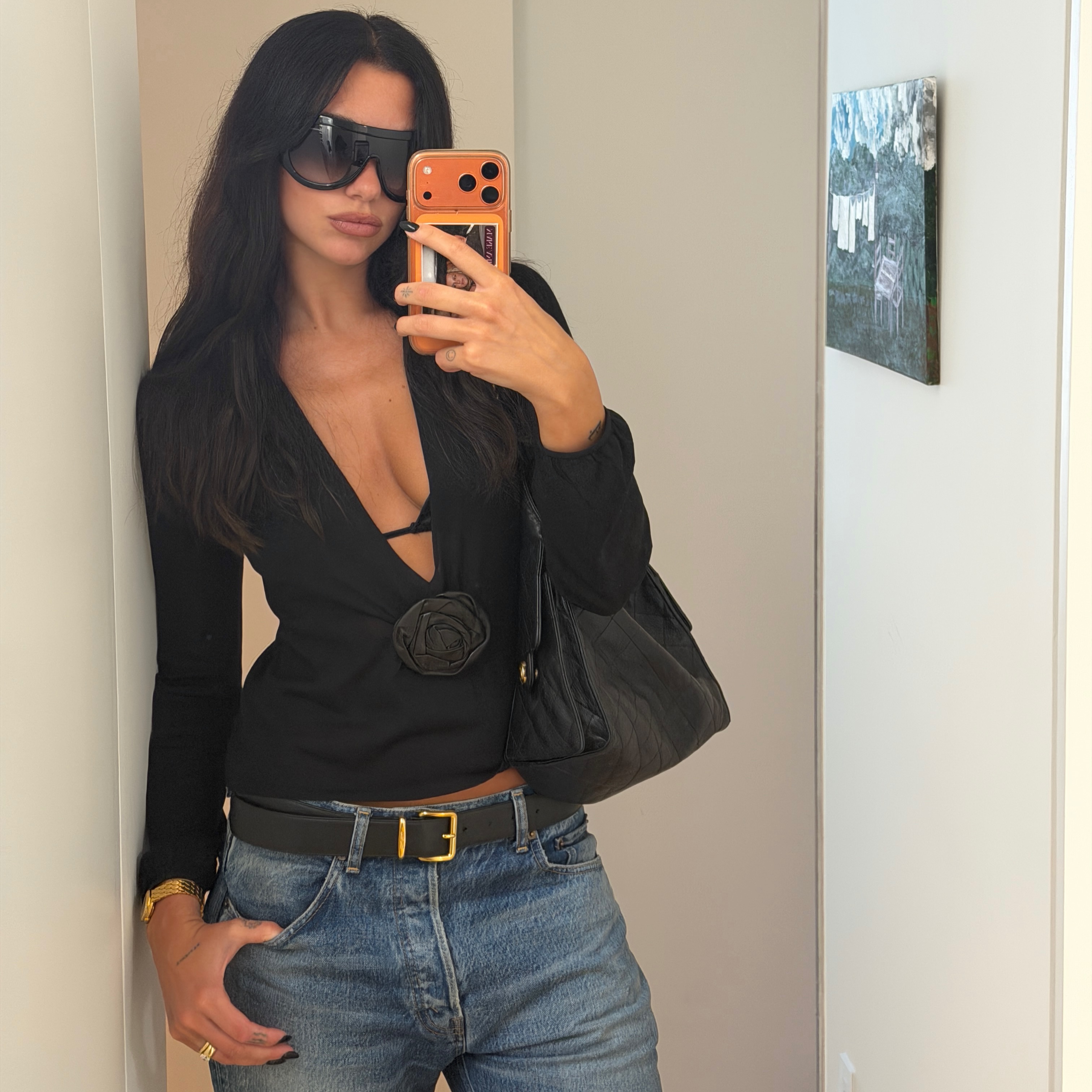 Dua Lipa wears a black top, jeans and visor sunglasses summer fashion trends 2026
