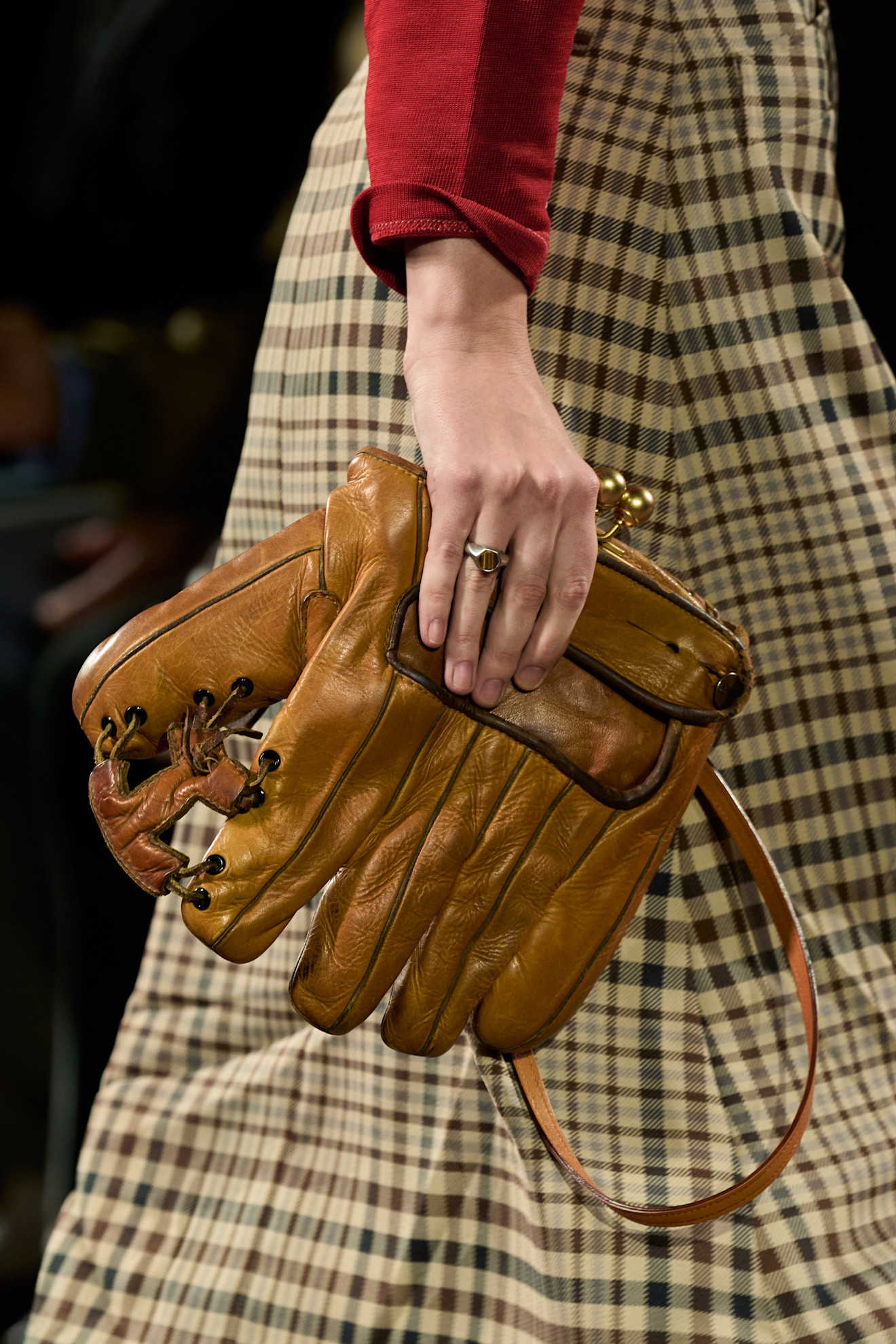 A model carrying a baseball glove Coach clutch bag at the F/W 26 show during New York Fashion Week.