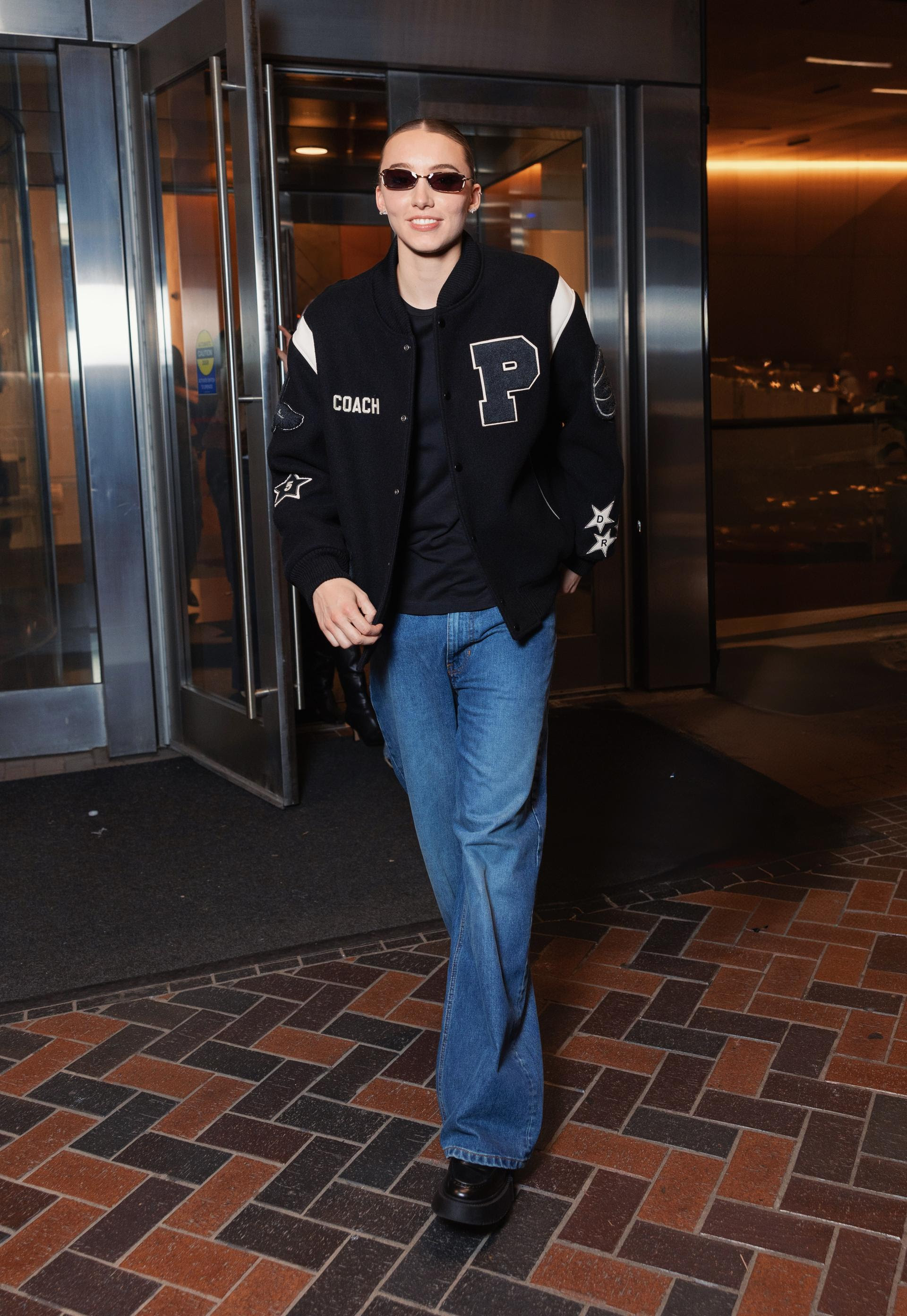 Paige Bueckers wearing a custom Coach varsity jacket with jeans during WNBA All-Star weekend in Chicago.