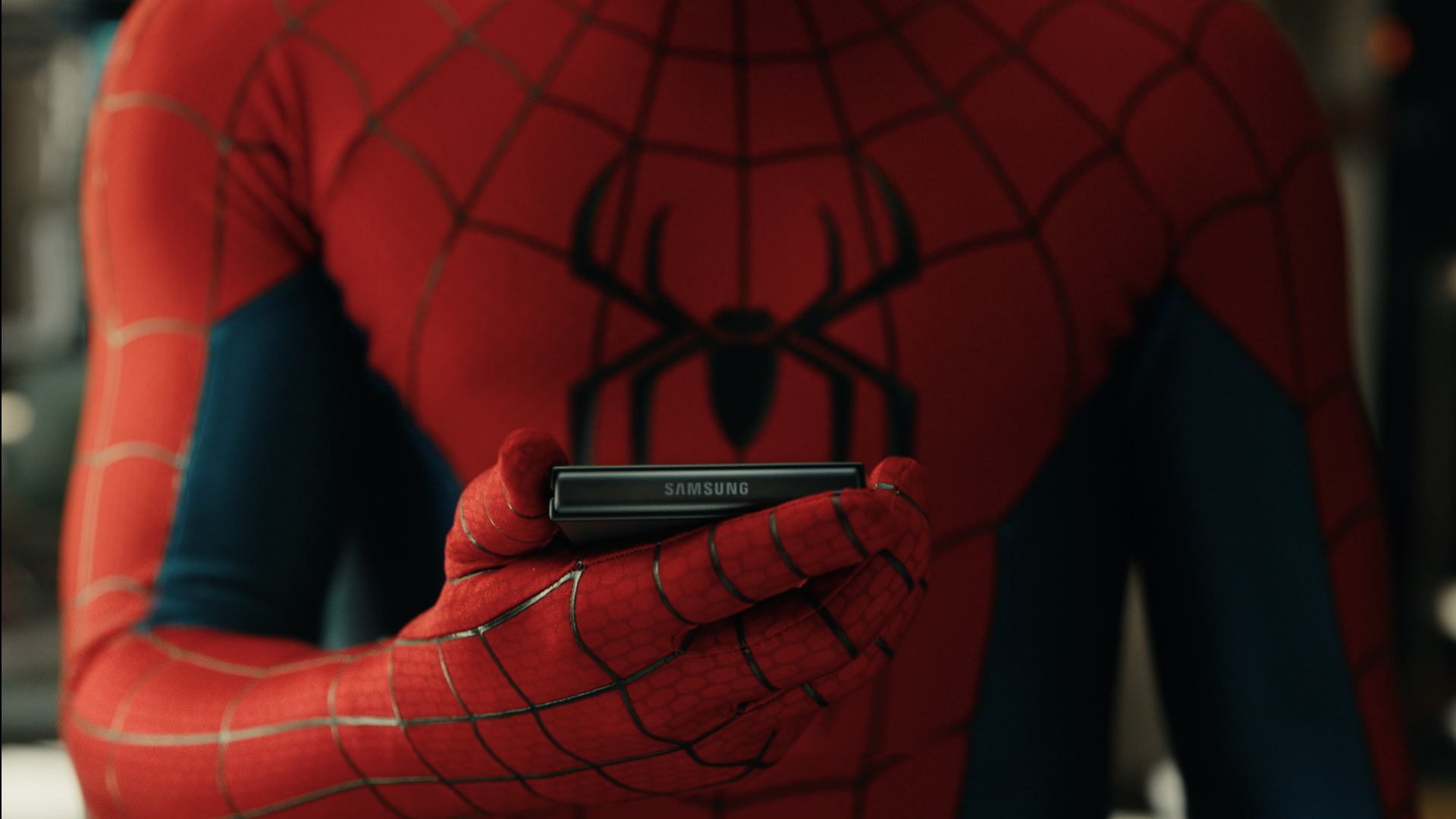 Spider-Man holding Samsung Galaxy Z Flip foldable smartphone