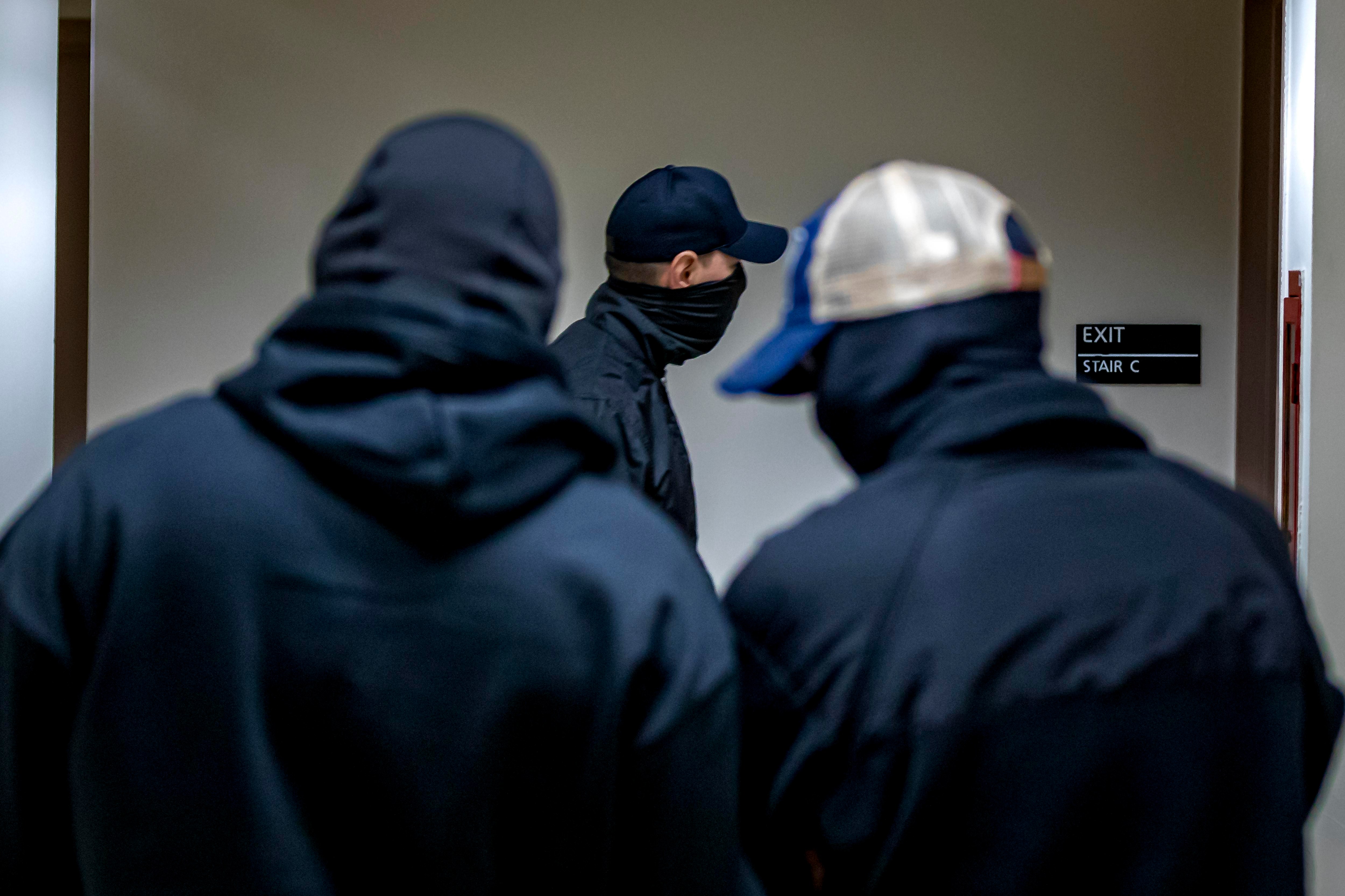 Federal agents patrol the halls of immigration court at the
