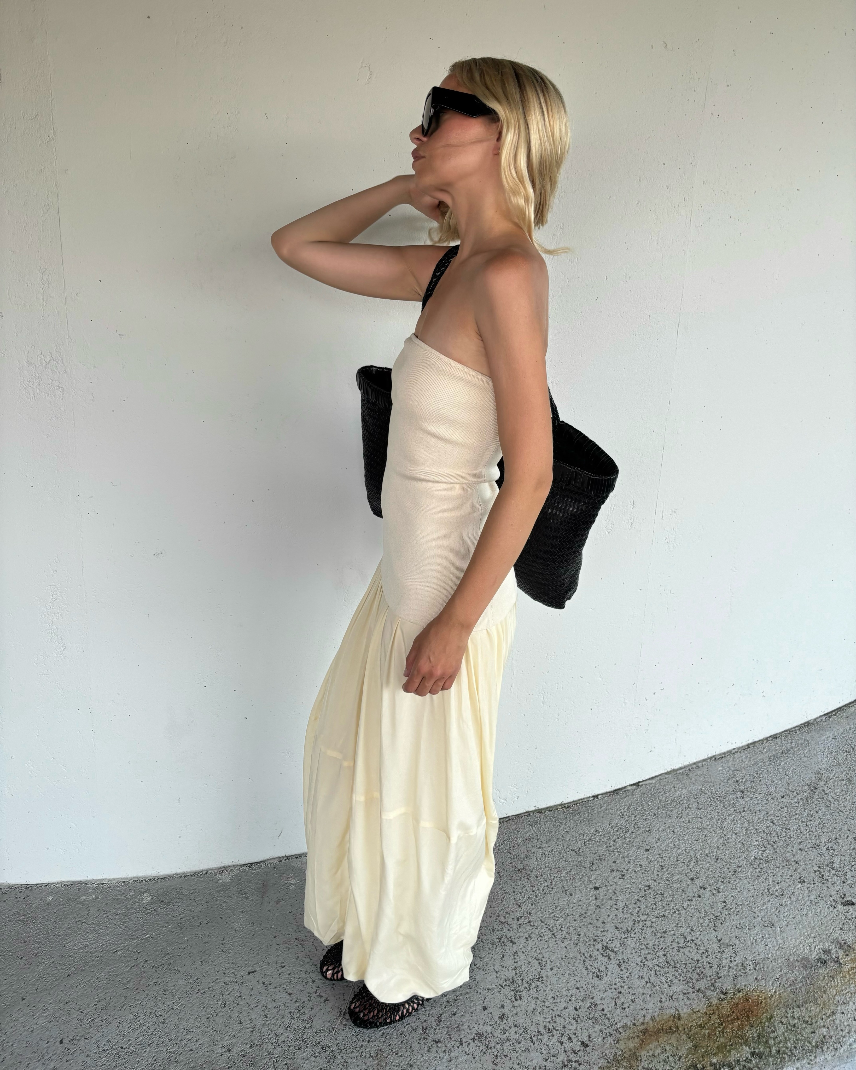 Stephanie Broek wearing a strapless dress and woven flats.