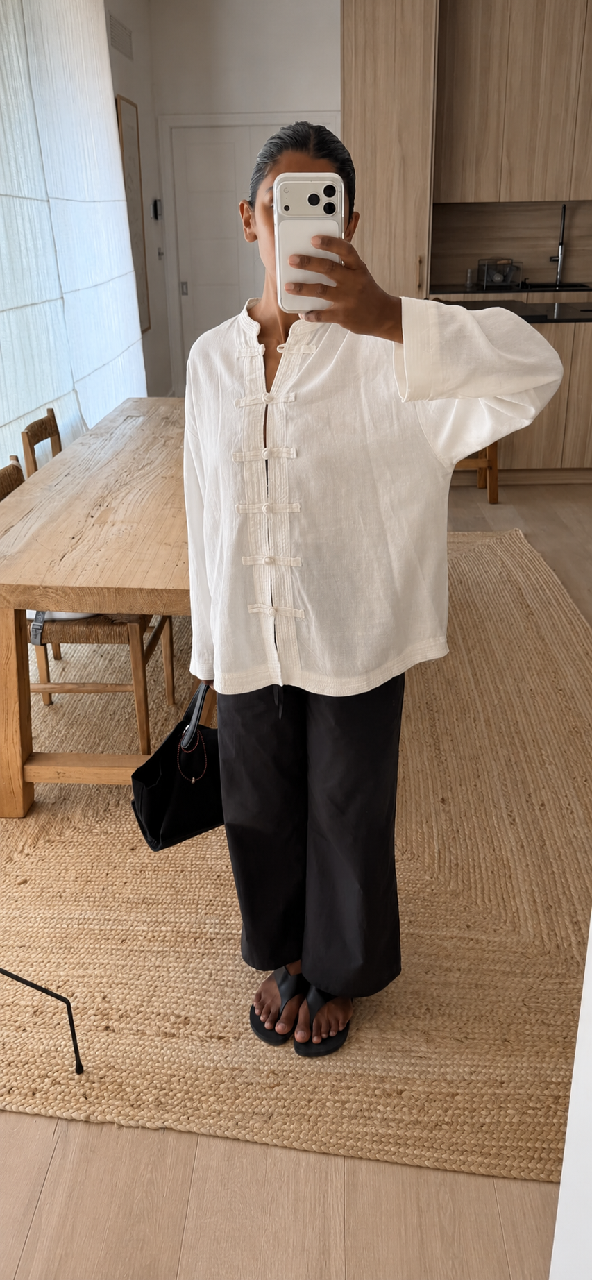 Woman wearing whit blouse and black trousers
