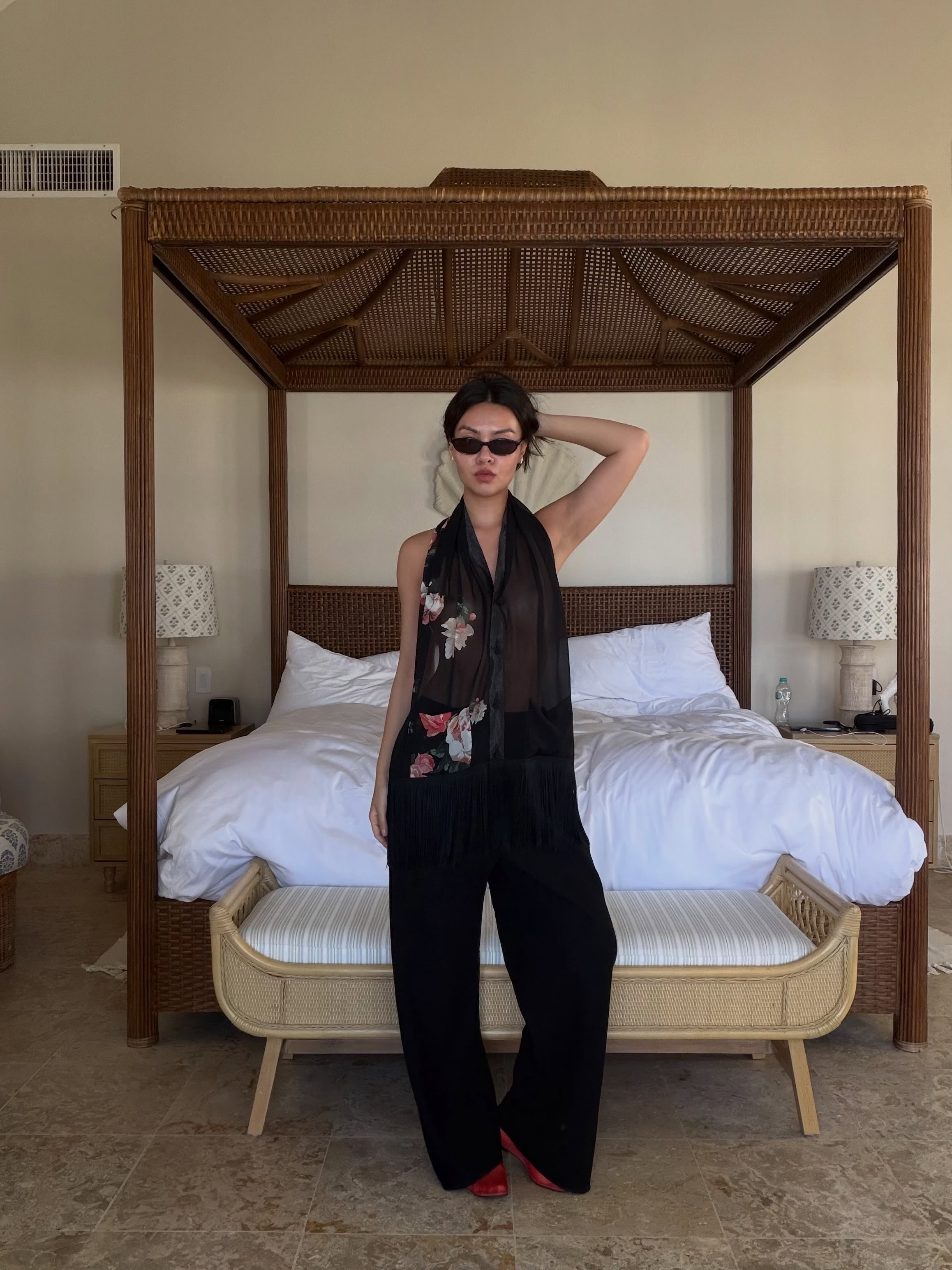 An image of @mimixn wearing mesh flats with a halterneck top and wide-leg trousers.